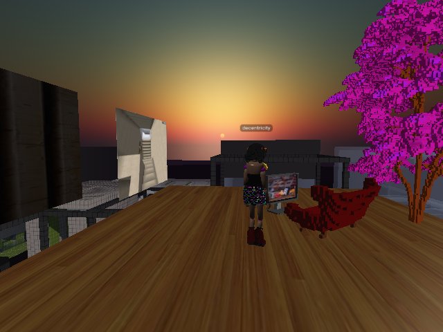 Just taking a womp of my zombie self looking at Brave Little Toaster on a flatscreen TV, while the sun sets on Cryptovoxels.